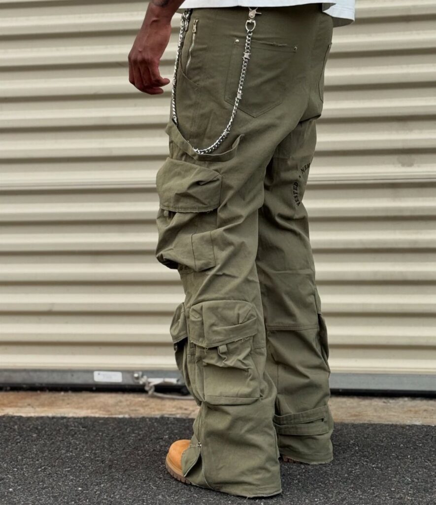 Person wearing olive green cargo pants with large pockets and a silver waist chain.